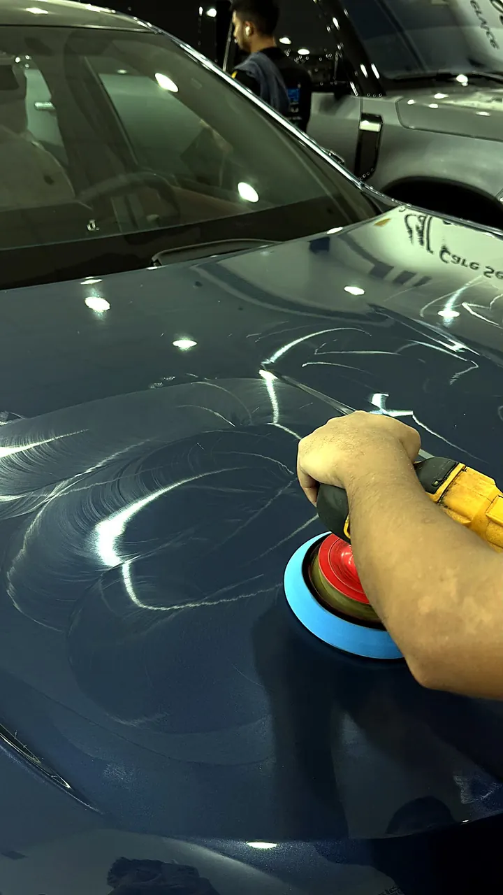Close-up machine polish on car hood — Shamil Trading